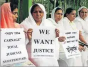  ?? AFP FILE ?? Relatives of Sikhs killed in the 1984 riots hold placards during a protest in New Delhi.