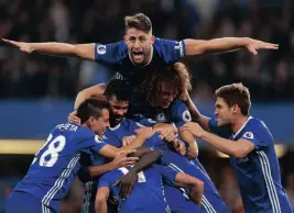  ??  ?? FLYING HIGH: With Gary Cahill executing a swallow-dive above them, Chelsea players celebrate their side’s fourth goal against Manchester United, by N’Golo Kante. REUTERS