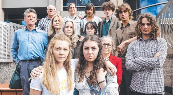  ??  ?? Claire Burgess and Stella McGill, front, with fellow Extinction Rebellion activists outside the Hobart Magistrate­s Court.