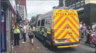  ??  ?? Police outside Adam’s Barbers in Week Street