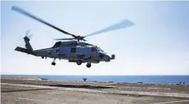  ?? PETTY OFFICER 2ND CLASS AMBER SMALLEY U.S. NAVY ?? An MH-60R Seahawk helicopter takes off from the flight deck of the Abraham Lincoln. A similar Navy helicopter operating from the ship crashed off the coast.