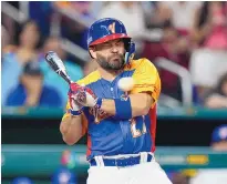  ?? WILFREDO LEE/ASSOCIATED PRESS ?? Jose Altuve is hit by a pitch while playing for Venezuela in a World Baseball Classic game against the United States on Saturday in Miami. ESPN reports he will miss at least two months.