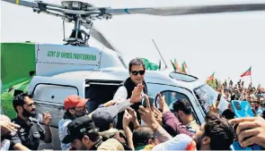  ?? ?? Pakistan’s ousted prime minister Imran Khan waves to supporters as he arrives by helicopter to lead a protest rally