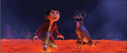  ?? The Associated Press ?? LATIN PRIDE: Characters Miguel, voiced by Anthony Gonzalez, left, and Dante in a scene from the animated film, "Coco."