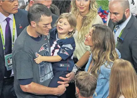  ?? MATT STONE / BOSTON HERALD ?? New England Patriots quarterbac­k Tom Brady holds his daughter Vivian as his wife, Gisele Bundchen, beams after Super Bowl LI in 2017.