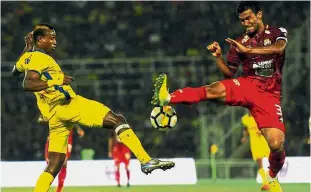  ?? — Bernama ?? One point apiece: Pahang’s Mohamadou Sumareh (left) vying for the ball with Perak’s Shahrul Mohd Saad during their Super League match on Sunday.