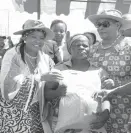  ??  ?? First Lady Auxillia Mnangagwa flanked by president of the Senate Mabel Chinomona (right) hands over seed of small grains to Ms Mainess Line during the World Internatio­nal Rural Women’s Day in Mbire yesterday
