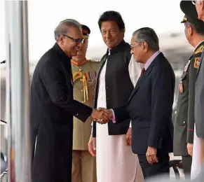  ??  ?? Strengthen­ing ties: Dr Arif sharing pleasantri­es with Dr Mahathir while Imran looks on during the Pakistan Day Parade at Shakar Parian Parade Ground in Islamabad. — Bernama