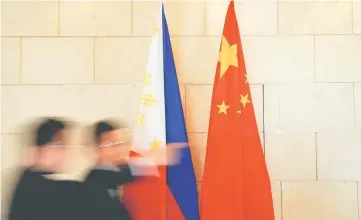  ??  ?? National flags are placed outside a room where Philippine Finance Secretary Carlos Dominguez and China’s Commerce Minister Gao Hucheng address reporters after their meeting in Beijing, China, January 23. China has agreed to cooperate with the...