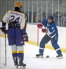  ?? Alexandra Wimley/Post-Gazette ?? Hempfield’s Trent Gray (4) shoots in the first round of the Class 2A playoffs against Plum on Monday at Pittsburgh Ice Arena in New Kensington.