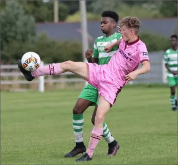  ??  ?? Stephen Kearns stretches to win this battle for the ball with Eric Abulu of Shamrock Rovers.