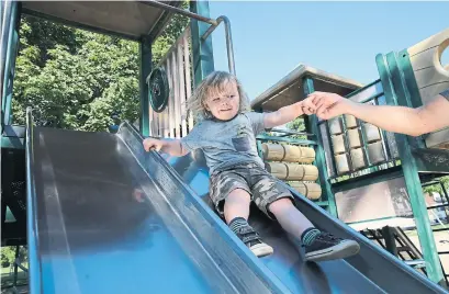  ?? RENÉ JOHNSTON TORONTO STAR ?? Holden Anderson, 2, enjoys the slide in a newly opened playground­s on Friday.