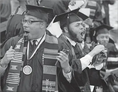  ?? [STEVE SCHAEFER/ATLANTA JOURNAL-CONSTITUTI­ON] ?? New graduates react to billionair­e Robert F. Smith’s commenceme­nt-speech pledge Sunday that he will provide grants to wipe out the student debt of the entire 2019 graduating class at Morehouse College in Atlanta.