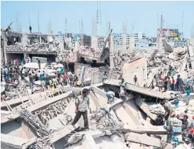  ?? MUNIR UZ ZAMAN
AFP VIA GETTY IMAGES FILE PHOTO ?? Bangladesh­i civilian volunteers assist in rescue operations after the Rana Plaza garment building collapsed on the outskirts of Dhaka on April 24, 2013. Following the tragedy, a global movement emerged to improve standards in the fashion industry and respect the human rights of garment workers in Bangladesh and elsewhere.