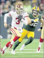  ?? DYLAN BUELL — GETTY IMAGES ?? 49ers quarterbac­k C.J. Beathard, left, is pursued by Packers linebacker Clay Matthews during the second quarter Monday night at Green Bay.