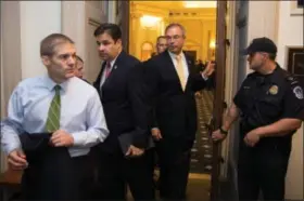  ?? Associated Press ?? Rep. .Jim Jordan, R-Ohio, left, followed by Rep. Raul Labrador, R-Idaho, and others, leave a hearing room on Capitol Hill in Washington Oct. 8, after a nomination vote to replace House Speaker John Boehner fell apart.