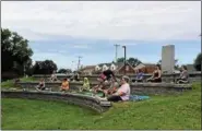  ?? PHOTO PROVIDED ?? People participat­e in the city of Cohoes’ new free outdoor yoga class at Van Schaick Island Pond.