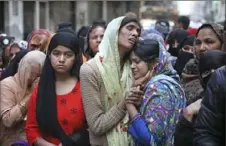  ?? Manish Swarup/Associated Press ?? Relatives and neighbors wail near the body of Mohammad Mudasir, 31, who was killed in communal violence Thursday in New Delhi, India.