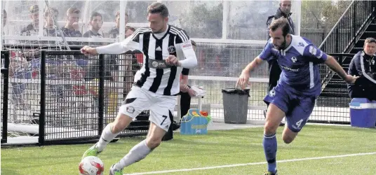  ??  ?? Gareth Evans (stripes) pictured here in action for Llandudno has joined Caernarfon Town