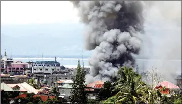  ??  ?? Smoke rises in the residentia­l neighbourh­ood of Marawi City as fighting rages between government soldiers and the Maute militant group, in southern Philippine­s. — Reuters photo