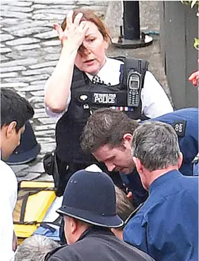  ??  ?? Distraught: Exhaustion and shock on the face of a policewoma­n