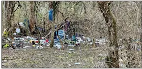  ?? (Courtesy Photo/City of Fayettevil­le) ?? Trash and debris is seen March 2 near Town Branch Trail east of Razorback Road in Fayettevil­le. The city has a plan to clean trash associated with unsanction­ed campsites along trails.