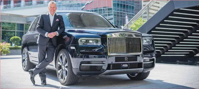  ??  ?? Torsten Müller-Ötvös, Chief Executive Officer by a Rolls-Royce Cullinan SUV