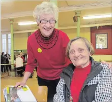  ?? SPECIAL TO THE EXAMINER ?? Rosemary Ganley (left) and A.J. McNaught (right) write letters at last year’s Write for Rights event.