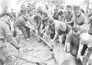  ?? — Gambar Bernama ?? TURUT SERTA: Ahmad Samsuri (dua, kiri) membantu melakukan ibadat korban Hari Raya Aidiladha pada program Korban Perdana Rhu Rendang semalam. Sebanyak 21 ekor lembu dikorbanka­n pada program tersebut.