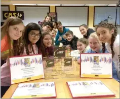  ?? Christina Cox/The Signal ?? Castaic Middle School CMS TV students pose in front of their Student Television Network awards at Castaic Middle School on Thursday.