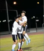  ??  ?? FROM LEFT, GILA RIDGE’S IAN MEZA, Arturo Ledezma and Esteban Franco celebrate Ledezma’s penalty-kick goal in the second half Friday at Veterans Memorial Stadium.