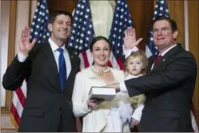  ?? JOSE LUIS MAGANA — THE ASSOCIATED PRESS FILE ?? In this file photo, House Speaker Paul Ryan of Wis. administer­s the House oath of office to Rep. Austin Scott, R-Ga., during a mock swearing in ceremony on Capitol Hill in Washington. The Republican newcomers stunned Washington in the 2010 midterm...