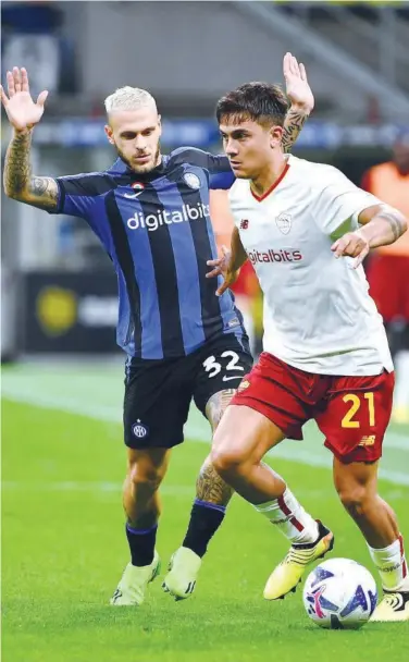  ?? Agence France-presse ?? AS Roma’s Paulo Dybala vies for the ball with Inter Milan’s Federico Dimarco (left) during their Italian League match on Saturday.