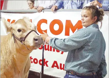  ?? Westside Eagle Observer/RANDY MOLL ?? Kassandra Tajchman, Gravette Gleamers 4-H, shows her animal during the 2019 junior premium livestock auction at the Benton County Fair.