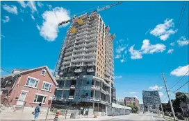  ?? MATHEW MCCARTHY WATERLOO REGION RECORD FILE PHOTO ?? The One Hundred condo tower under constructi­on on Victoria Street, seen in July, is one of the new developmen­t projects changing the landscape in downtown Kitchener.