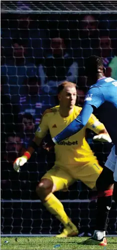  ?? ?? Abdallah Sima sends the ball into the net for Rangers’ second goal after climbing off the bench