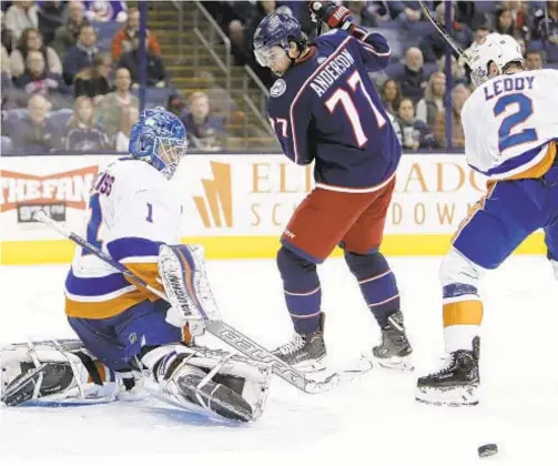  ?? AP ?? Islanders goalie Thomas Greiss turns away shot as teammate Nick Leddy and Columbus Blue Jackets’ Josh Anderson look for rebound.