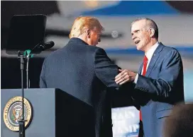  ?? [AP PHOTO] ?? In this Oct. 18 photo, President Donald Trump and Montana State Auditor Matt Rosendale, who is running against Sen. Jon Tester, D-Mont., shake hands during a campaign rally in Missoula, Mont.