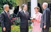  ?? ASSOCIATED PRESS FILE PHOTO ?? From left, then-President George W. Bush watches the swearing-in of Brett Kavanaugh in 2006, as judge for the U.S. Court of Appeals for the District of Columbia by U.S. Supreme Court Associate Justice Anthony Kennedy, right, at the White House. Holding the Bible is Kavanaugh’s wife, Ashley Kavanaugh. The Supreme Court nominee has stepped up to make a play at key moments in politics.