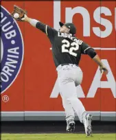  ?? Mark J. Terrill The Associated Press ?? Athletics center fielder Ramon Laureano catches a ball hit by Justin Upton in the third inning of the Angels’ 7-0 home loss Saturday.