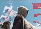  ?? — AFP ?? People walk past presidenti­al campaign banners in Istanbul on Tuesday.