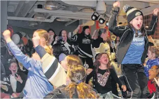  ?? ARDELLE REYNOLDS • CAPE BRETON POST ?? The moment Sydney was named winner of the Kraft Hockeyvill­e national contest Saturday night, female hockey players of all ages jumped up in celebratio­n amid screams and hugs at Cape Breton University’s pub, The Pit.