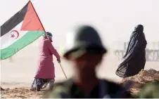  ?? — AFP file photo ?? A Sahrawi woman holds a Polisario Front’s flag during a ceremony to mark 40 years after the Front proclaimed the Sahrawi Arab Democratic Republic (SADR) in the disputed territory of Western Sahara.
