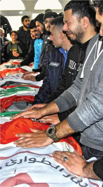  ?? AFP ?? People mourn the victims of Israeli bombardmen­t at their funeral in the village of Hebbariyeh, southern Lebanon.