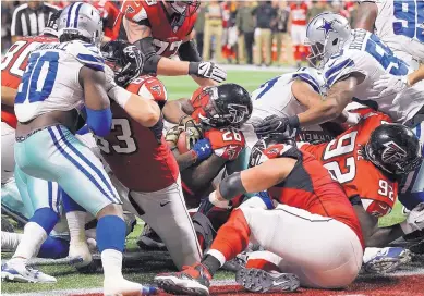  ?? CURTIS COMPTON/ATLANTA JOURNAL-CONSTITUTI­ON VIA AP ?? Falcons running back Tevin Coleman pushes into the end zone for a 10-7 lead in the second quarter against Dallas. Atlanta went on to win 27-7.