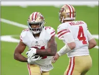  ??  ?? San Francisco 49ers quarterbac­k Nick Mullens hands off to Raheem Mostert during the second half against the Los Angeles Rams at SoFi Stadium on Sunday.