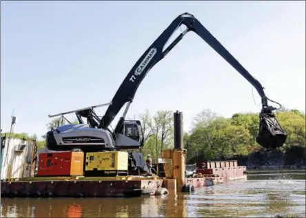  ?? THE ASSOCIATED PRESS FILE ?? On May 7, 2015, crews perform dredging work along the upper Hudson River in Waterford, N.Y.