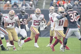  ?? NAM Y. HUH — THE ASSOCIATED PRESS ?? 49ers running back Eli Mitchell, center, rushed for 137 yards and a touchdown on 18 carries in Sunday’s win.