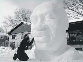  ?? AP ?? George Floyd brought our future forward. A resident of Quebec
City puts the finishing touches to a sculpture of him in front of his house