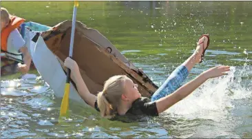  ?? Blake Doss / Rome News-Tribune ?? Coosa Middle student Marissa Page, 13, splashes into the water as her cardboard boat sinks in Rolater Lake on Saturday.